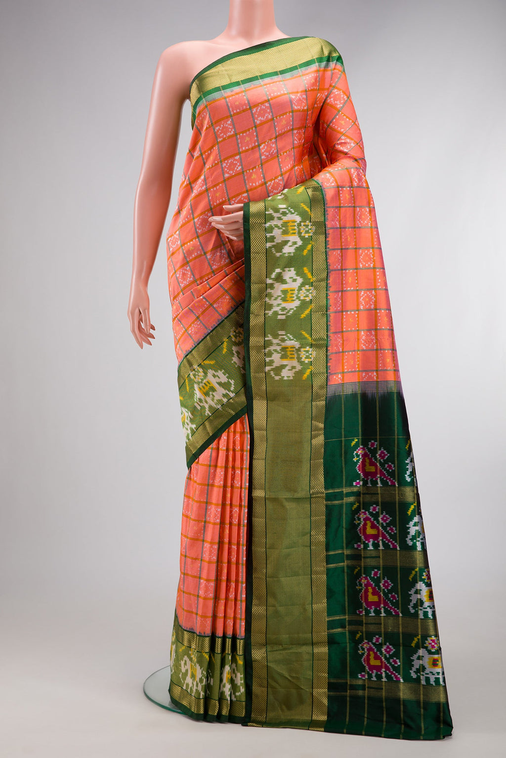 Peach Dual Tone Double Ikat Saree with Ikat Print on the body and Ikat Border.  displayed on a mannequin