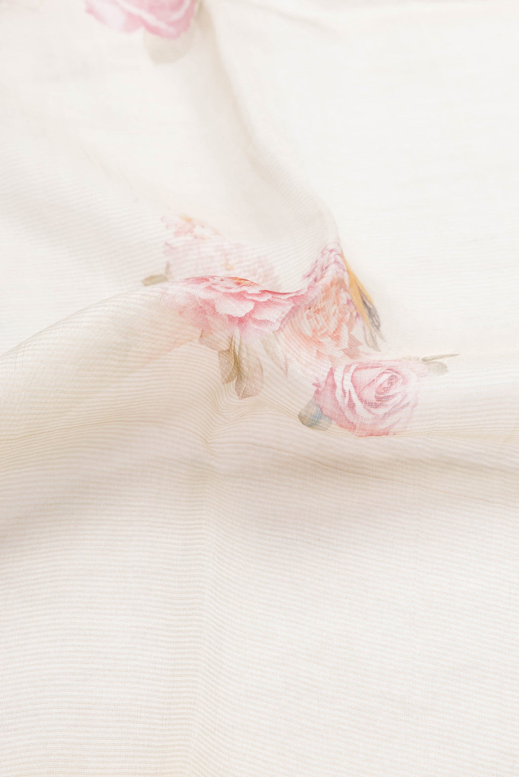 Close up of Beige Dual Tone Tussar Silk Saree with Printed design on the body and Printed Border.  displaying folds