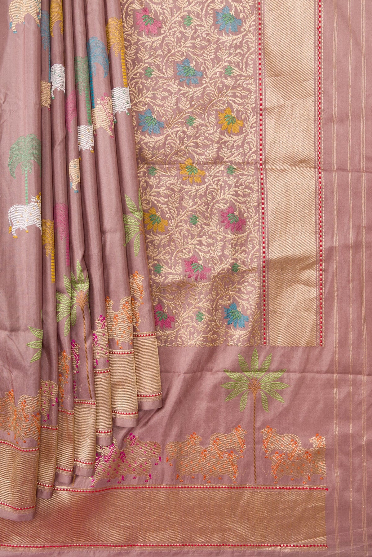 Pleats and pallu of Rose Gold Dual Tone Banarasi Silk Saree with Zari And Thread Butta on the body and Fancy Border. 