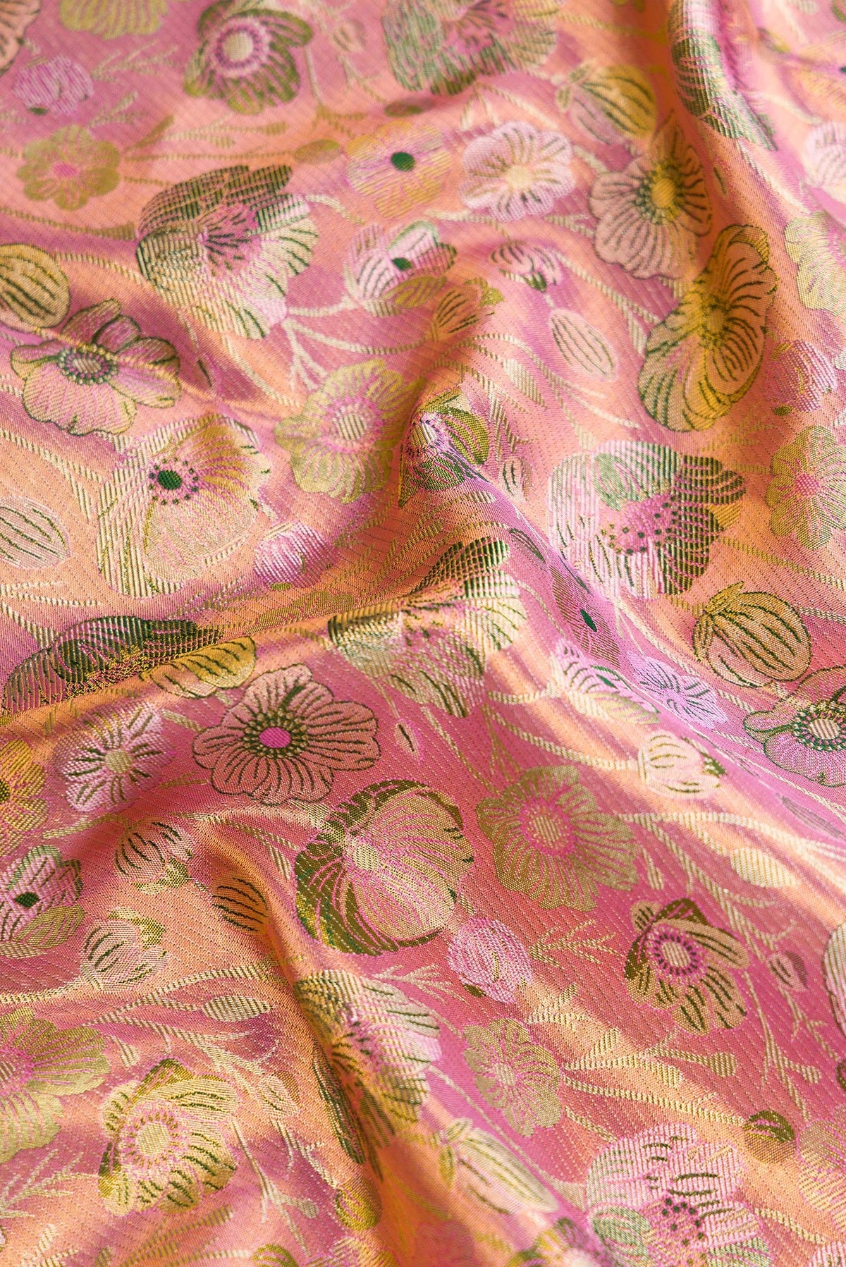 Close up of Pink Dual Tone Kanjivaram Tissue Silk Saree with Zari Brocade on the body and Zari Border.  displaying folds
