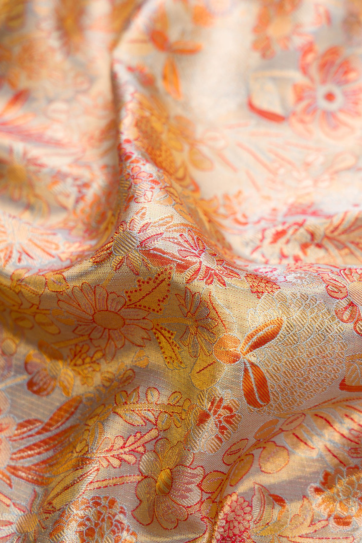 Close up of Lilac with Gold Color Kanjivaram Tissue Silk Saree with Zari Brocade on the body and Zari Border.  displaying folds