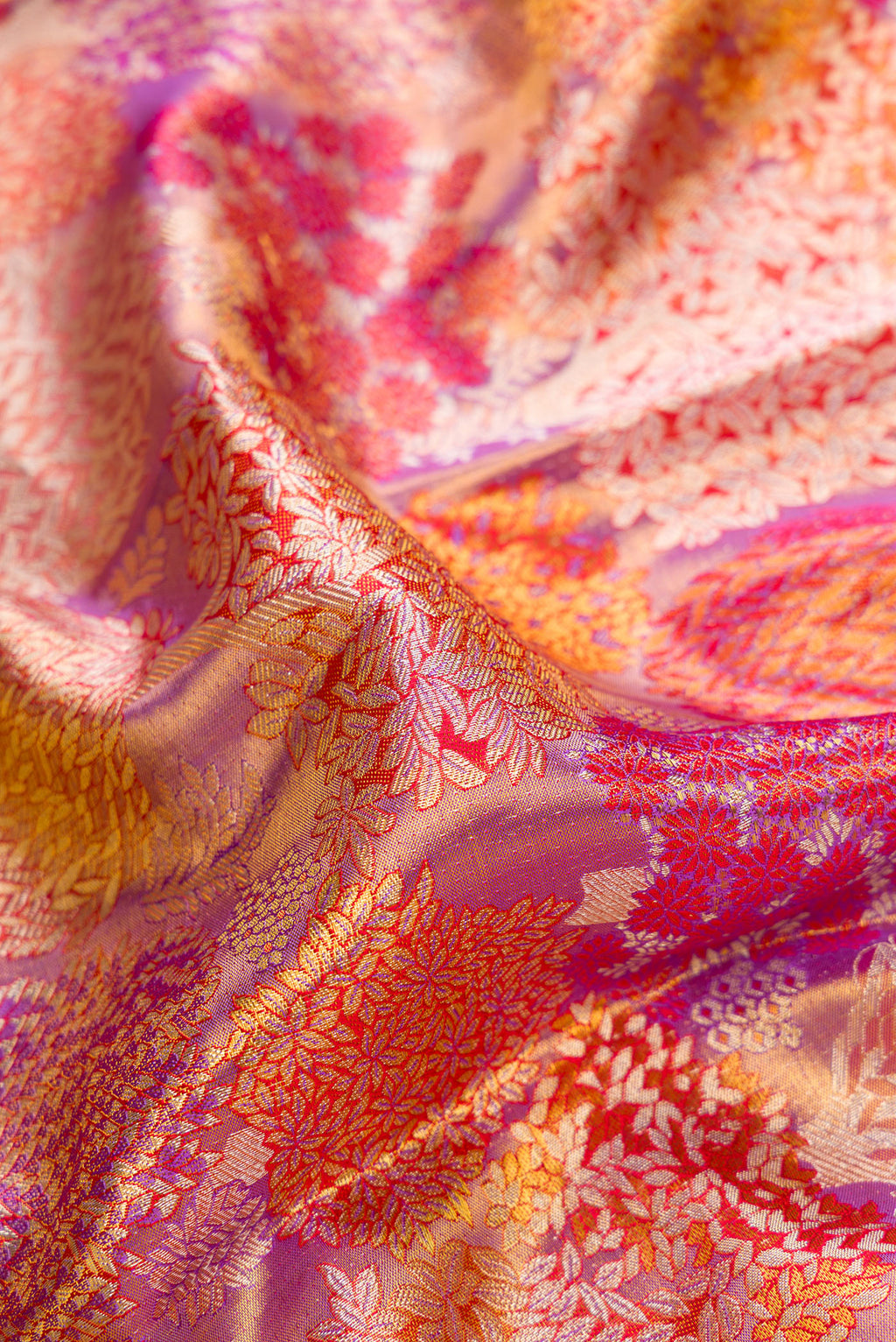 Close up of Purple Dual Tone Kanjivaram Tissue Silk Saree with Zari Brocade on the body and Zari Border.  displaying folds