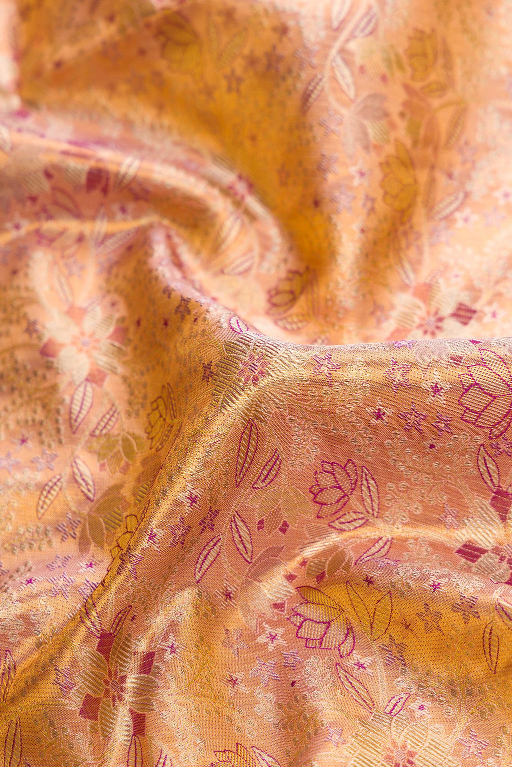 Close up of Gold Dual Tone Kanjivaram Tissue Silk Saree with Zari Brocade on the body and Zari Border.  displaying folds