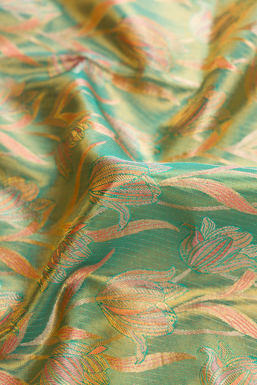 Close up of Green Kanjivaram Tissue Silk Saree with Zari Brocade on the body and Fancy Border.  displaying folds