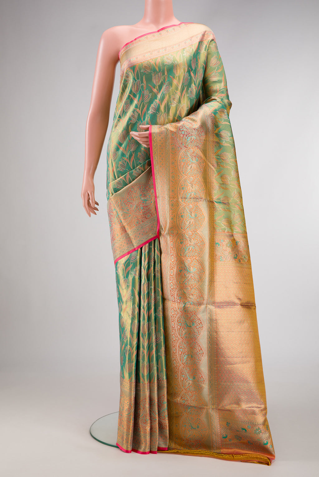 Green Kanjivaram Tissue Silk Saree with Zari Brocade on the body and Fancy Border.  displayed on a mannequin