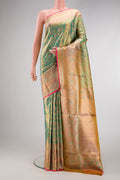 Green Kanjivaram Tissue Silk Saree with Zari Brocade on the body and Fancy Border.  displayed on a mannequin