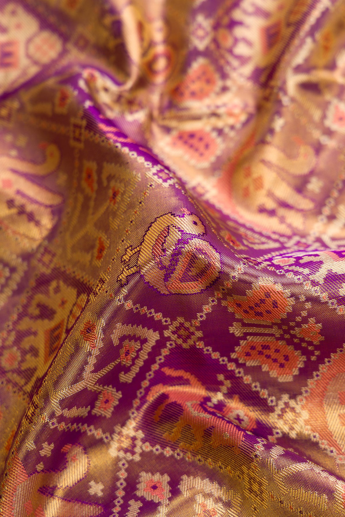 Close up of Purple Dual Tone Kanjivaram Tissue Silk Saree with Zari Brocade on the body and Zari Border.  displaying folds