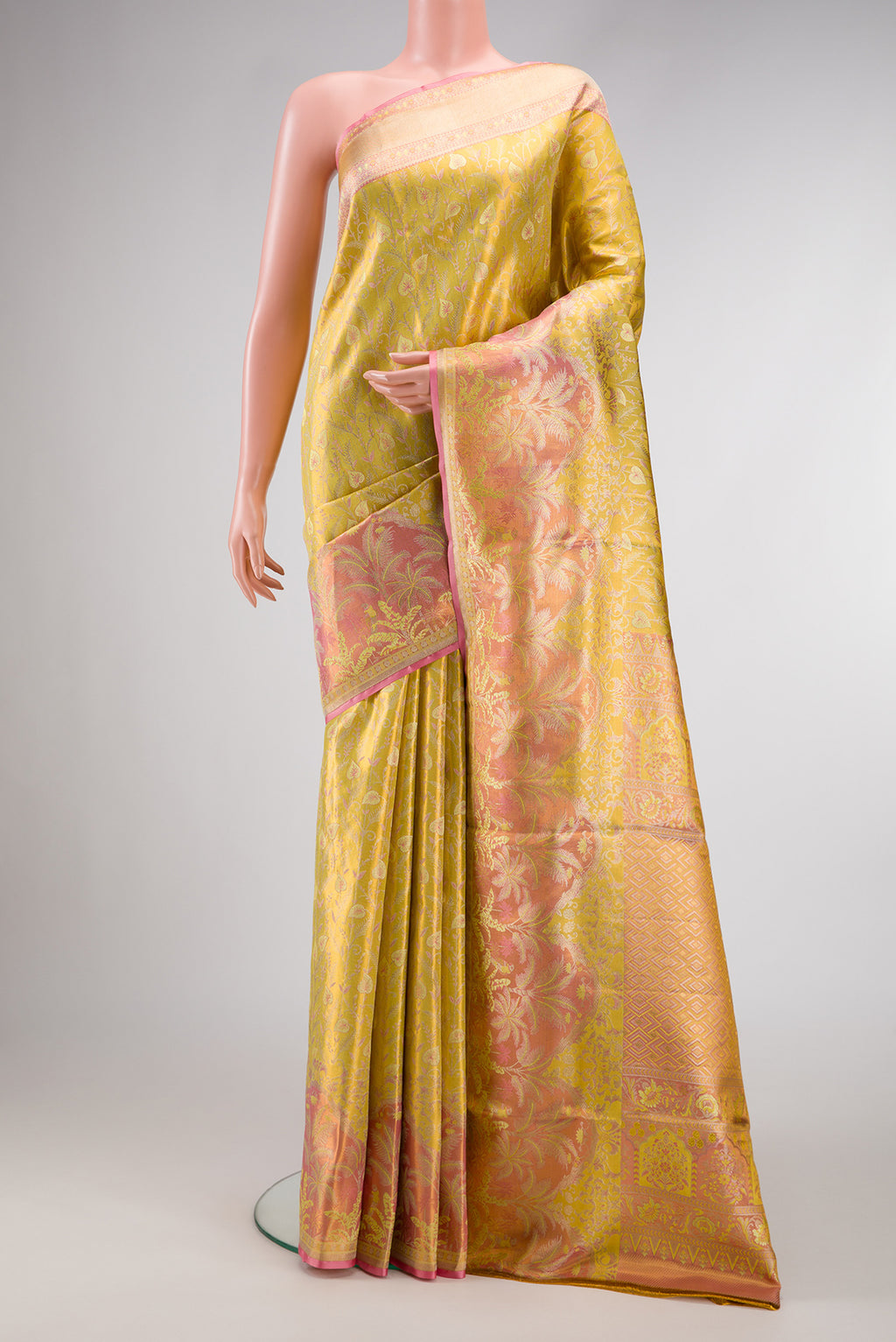 Yellow Kanjivaram Tissue Silk Saree with Zari Brocade on the body and Fancy Border.  displayed on a mannequin