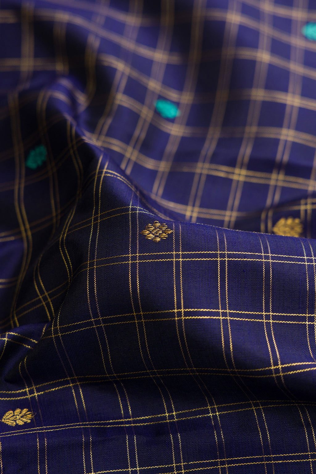 Close up of Royal Blue Dual Tone Kanjivaram Silk Saree with Zari Butta on the body and Zari Border.  displaying folds