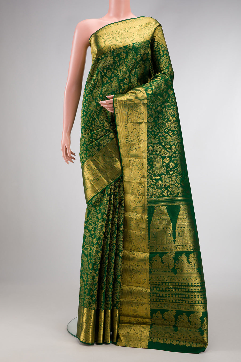 Green Kanchipuram Silk Saree with Zari Butta on the body and Zari Border.  displayed on a mannequin
