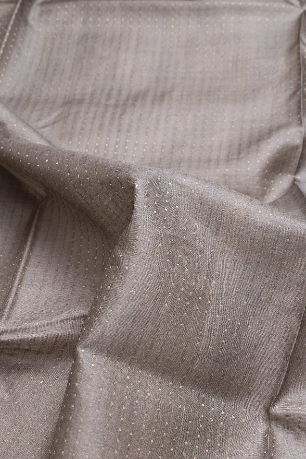 Close up of Grey Dual Tone Tussar Silk Saree with Stripes on the body and Printed Border.  displaying folds
