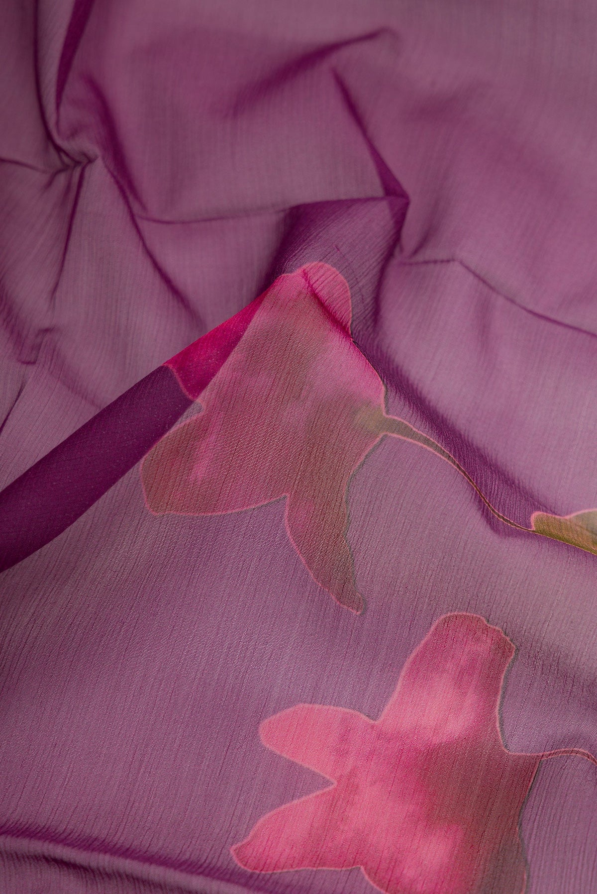 Close up of Purple Dual Tone Mysore Chiffon Saree with Printed design on the body and Without Border.  displaying folds