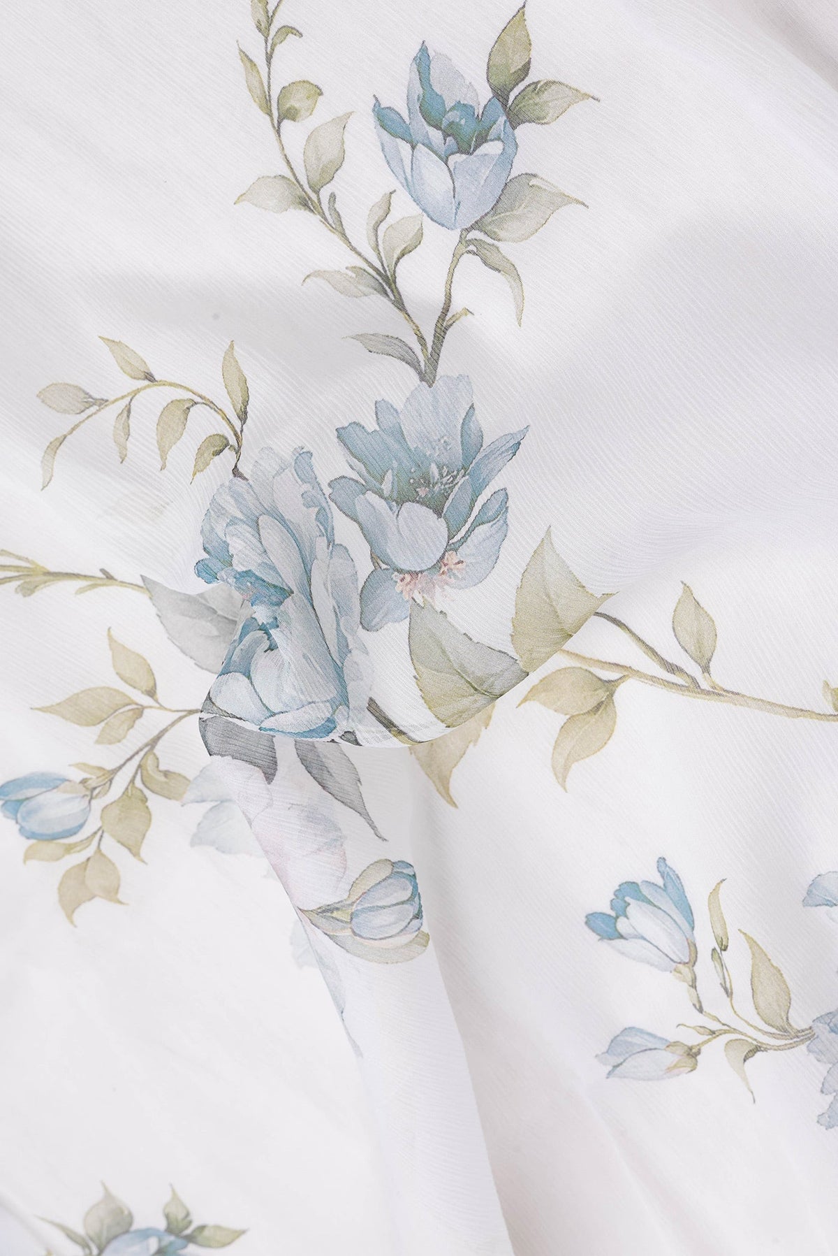 Close up of Off White Dual Tone Mysore Chiffon Saree with Printed design on the body and Plain Border.  displaying folds
