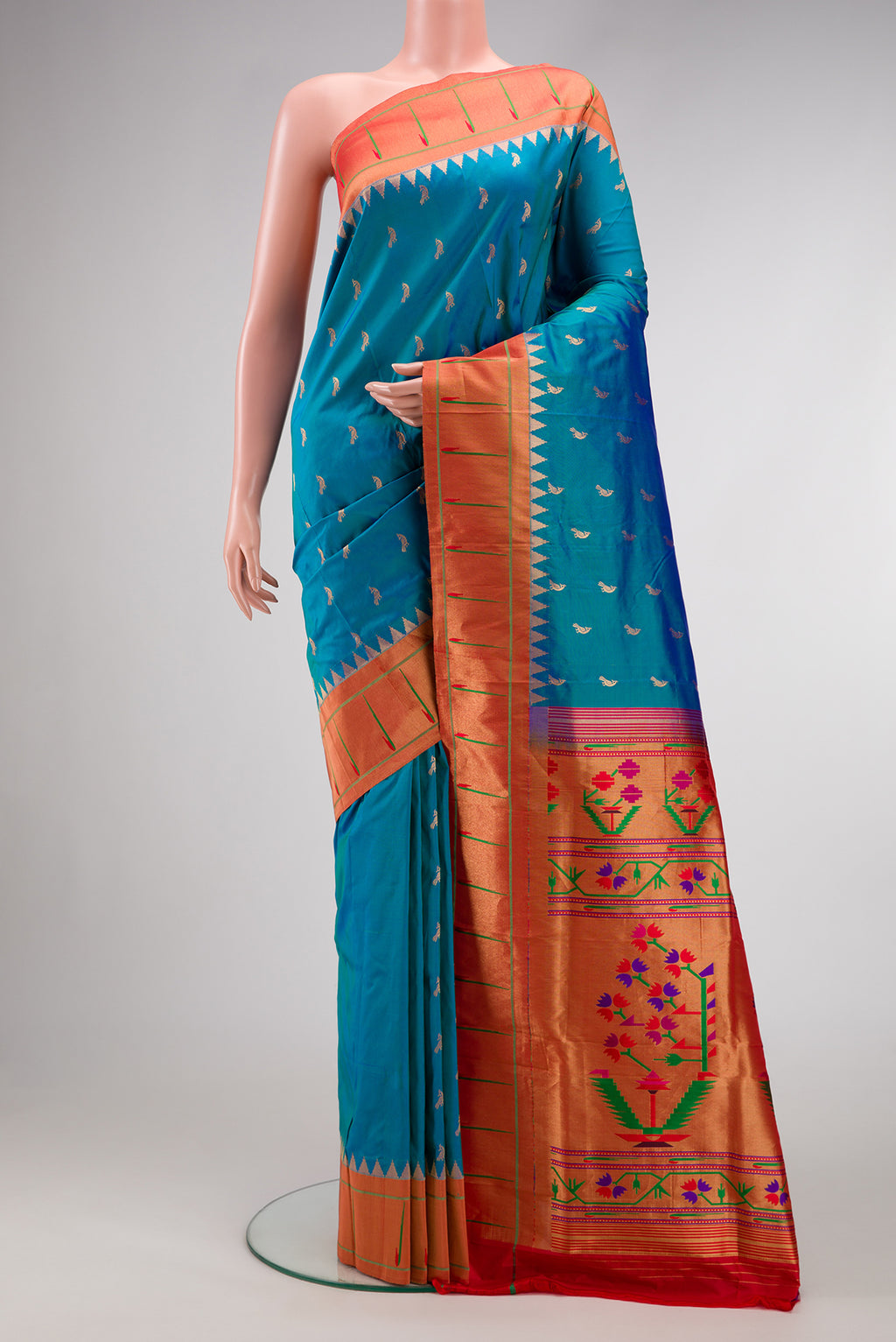 Blue Paithani Silk Saree with Zari Butta on the body and Paithani Border.  displayed on a mannequin