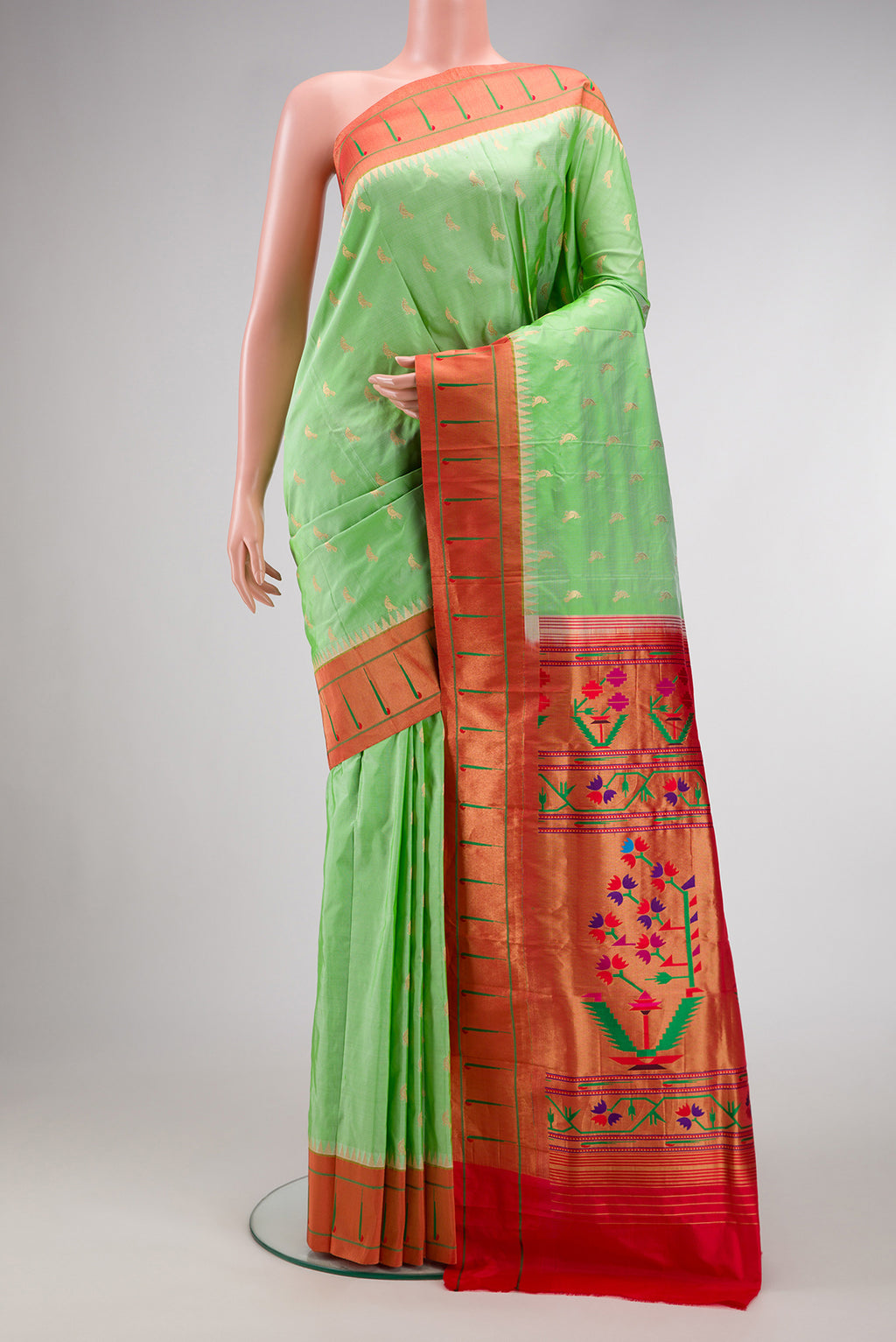 Pista Green Paithani Silk Saree with Zari Butta on the body and Paithani Border.  displayed on a mannequin