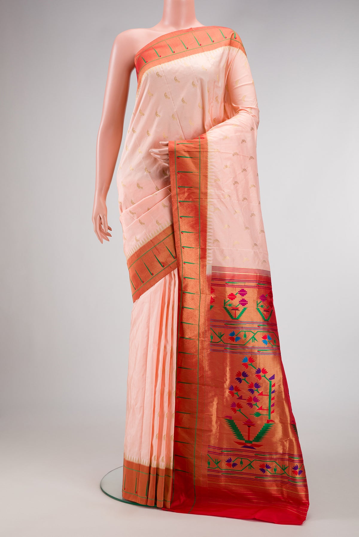 Peach Paithani Silk Saree with Zari Butta on the body and Paithani Border.  displayed on a mannequin