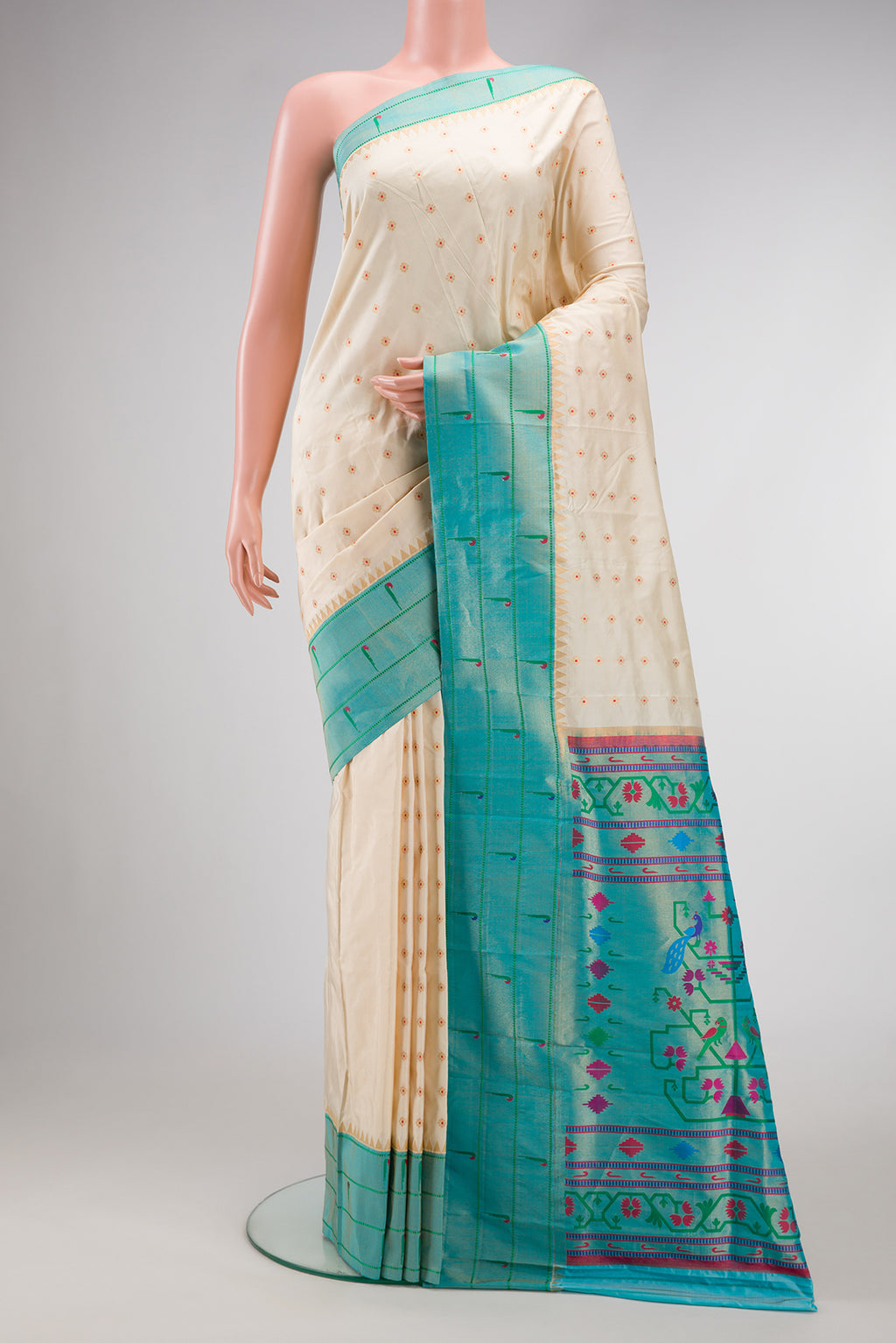 Cream Paithani Silk Saree with Zari Butta on the body and Paithani Border.  displayed on a mannequin