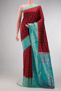 Maroon Paithani Silk Saree with Zari Butta on the body and Paithani Border.  displayed on a mannequin