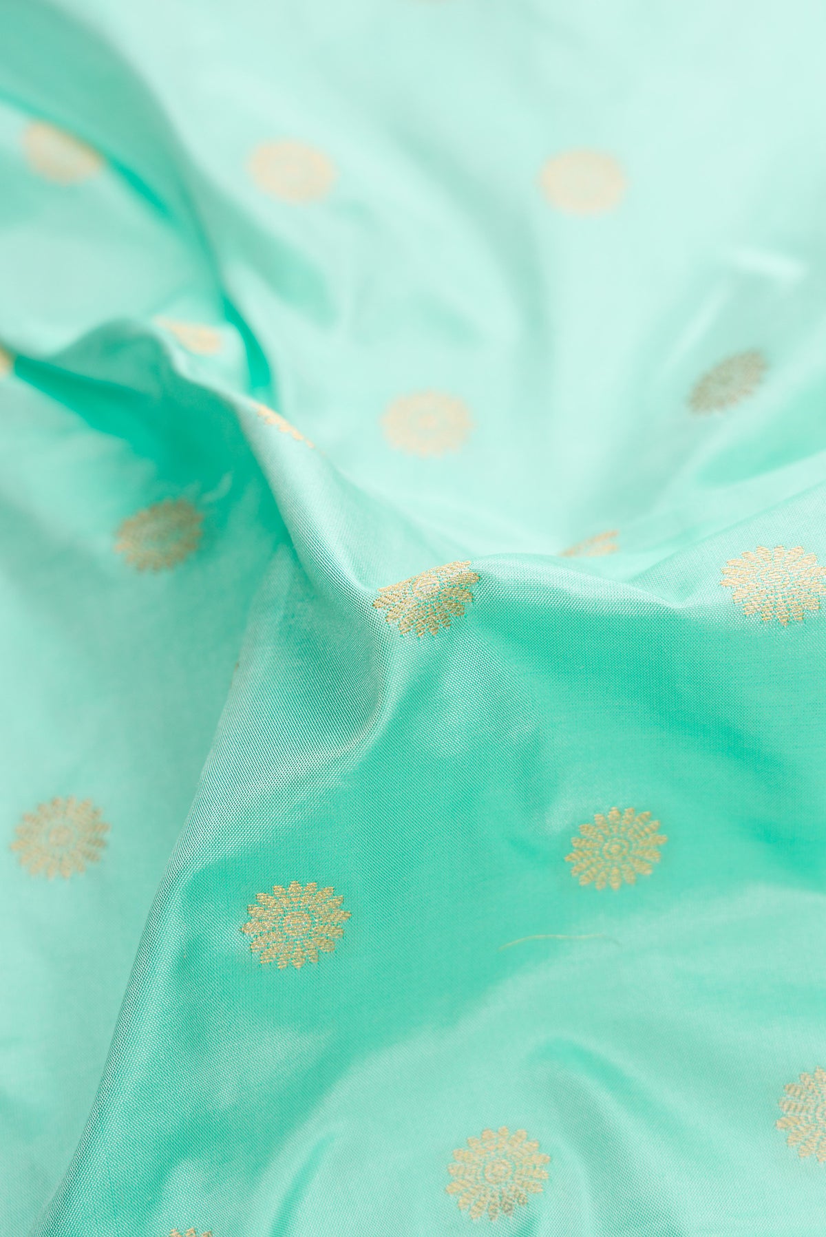 Close up of Blue Paithani Silk Saree with Zari Butta on the body and Paithani Border.  displaying folds