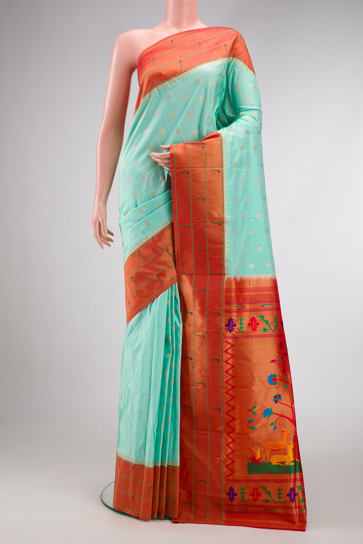 Blue Paithani Silk Saree with Zari Butta on the body and Paithani Border.  displayed on a mannequin