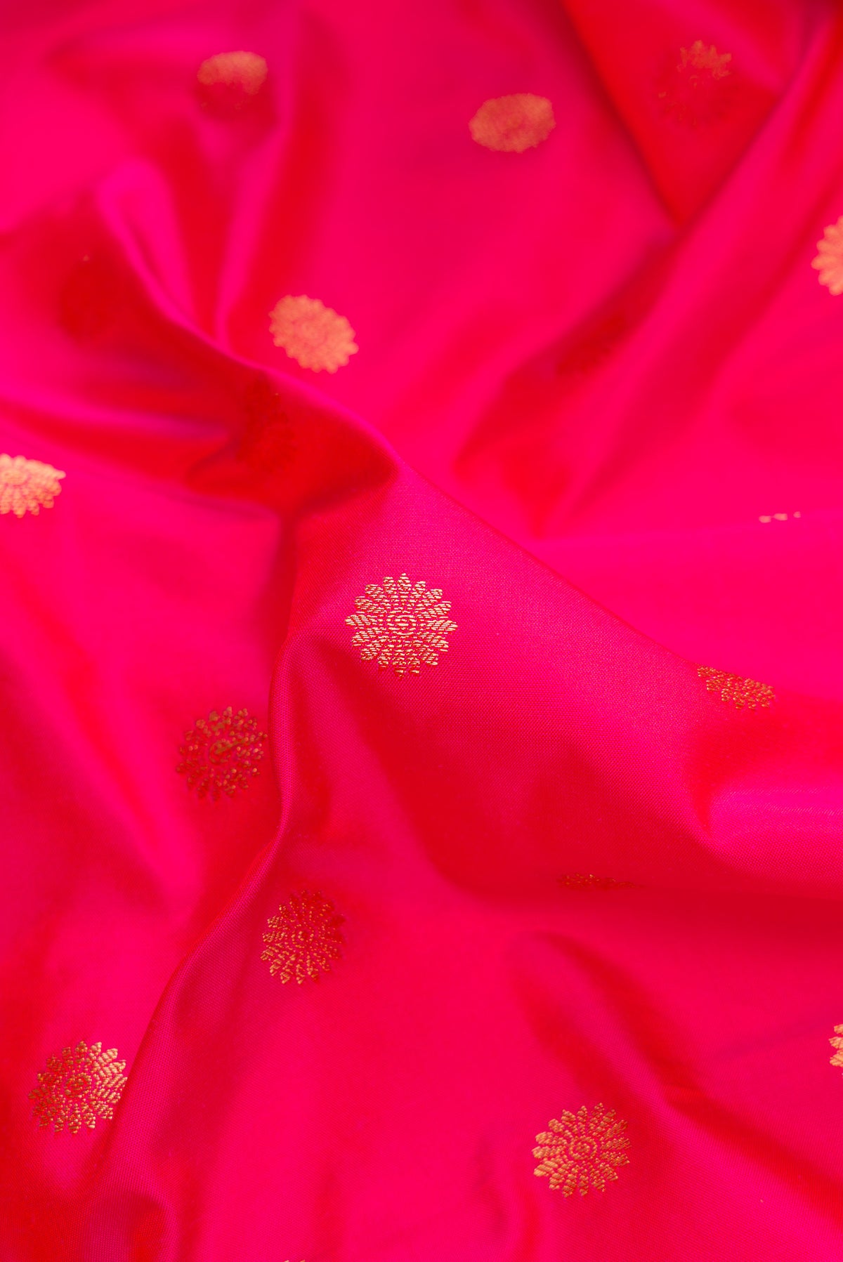 Close up of Pink Paithani Silk Saree with Zari Butta on the body and Paithani Border.  displaying folds