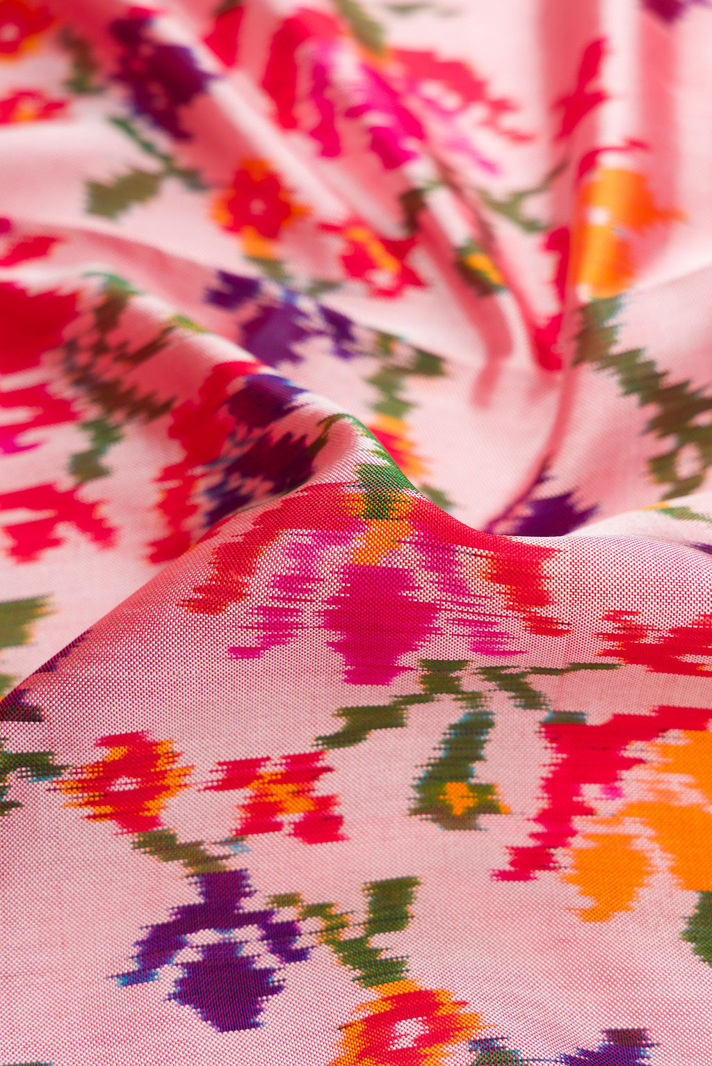 Close up of Rose pink Double Ikat Saree with Pure Ikat on the body and Ikat Border.  displaying folds