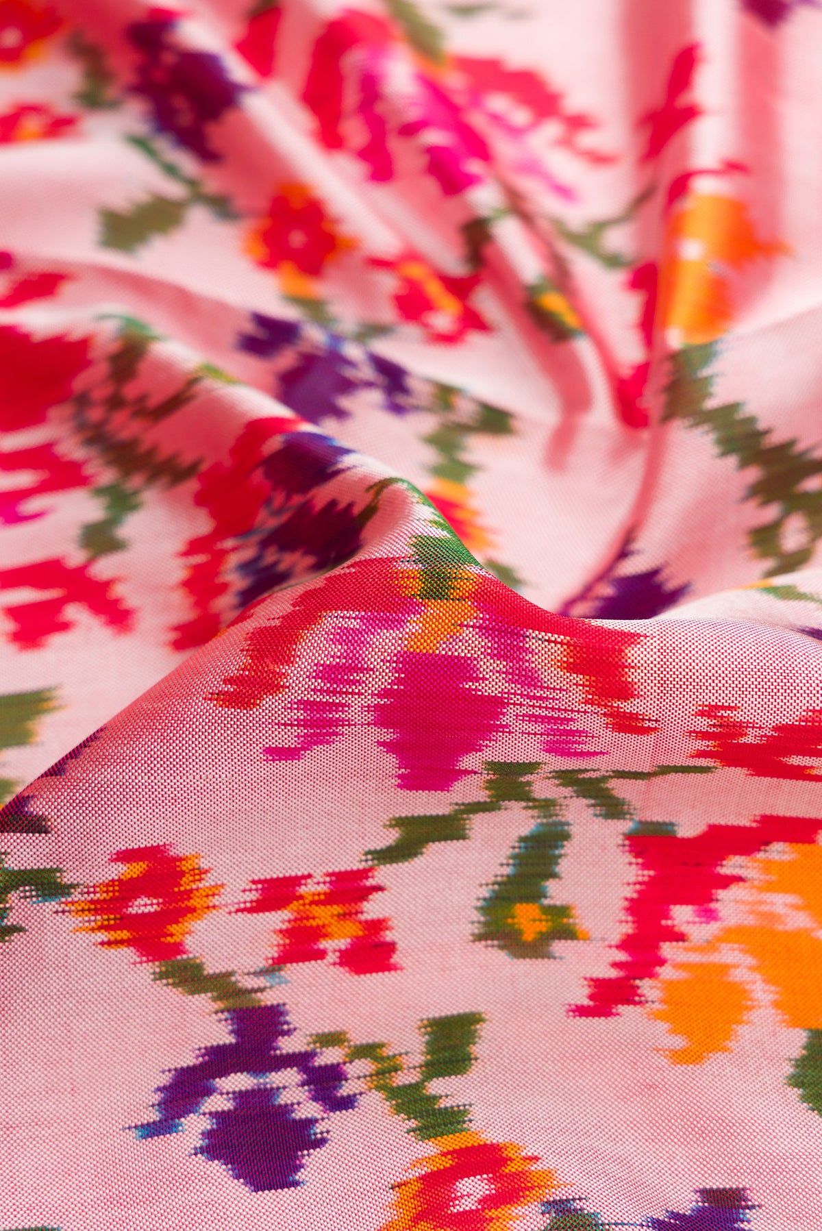 Close up of Rose pink Double Ikat Saree with Pure Ikat on the body and Ikat Border.  displaying folds