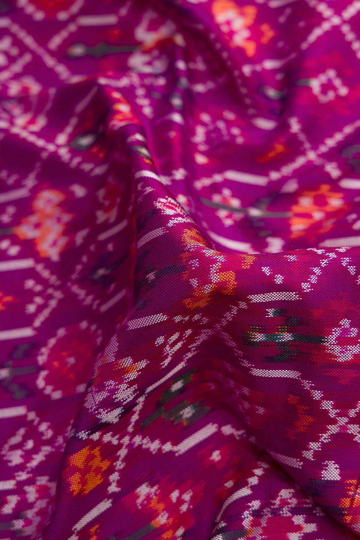 Close up of Purple Dual Tone Double Ikat Saree with Ikat Print on the body and Zari Border.  displaying folds