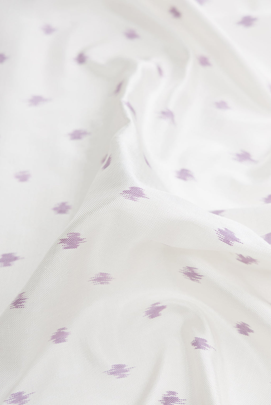 Close up of Off White Dual Tone Double Ikat Saree with Ikat Print on the body and Ikat Border.  displaying folds
