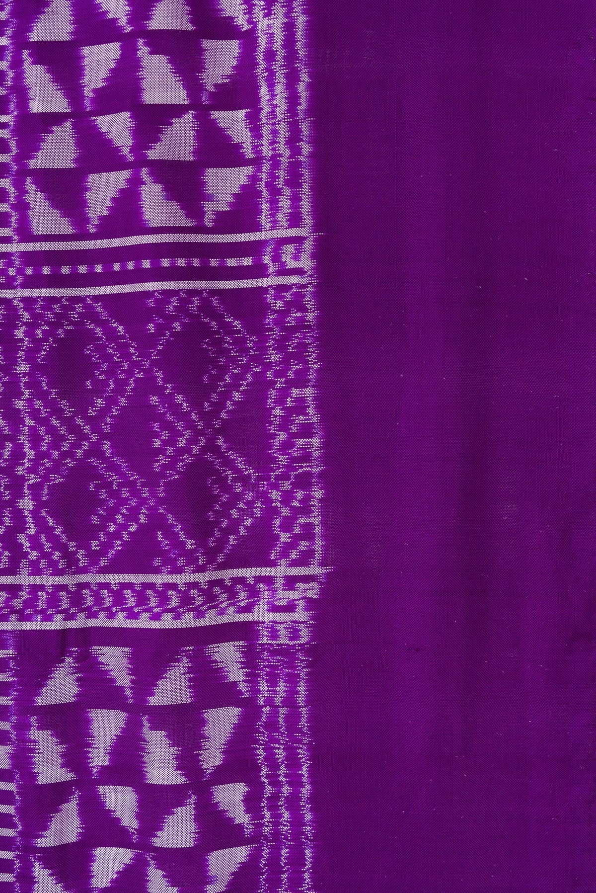 Border image of Violet Dual Tone Double Ikat Saree with Ikat Print on the body and Plain Border. 