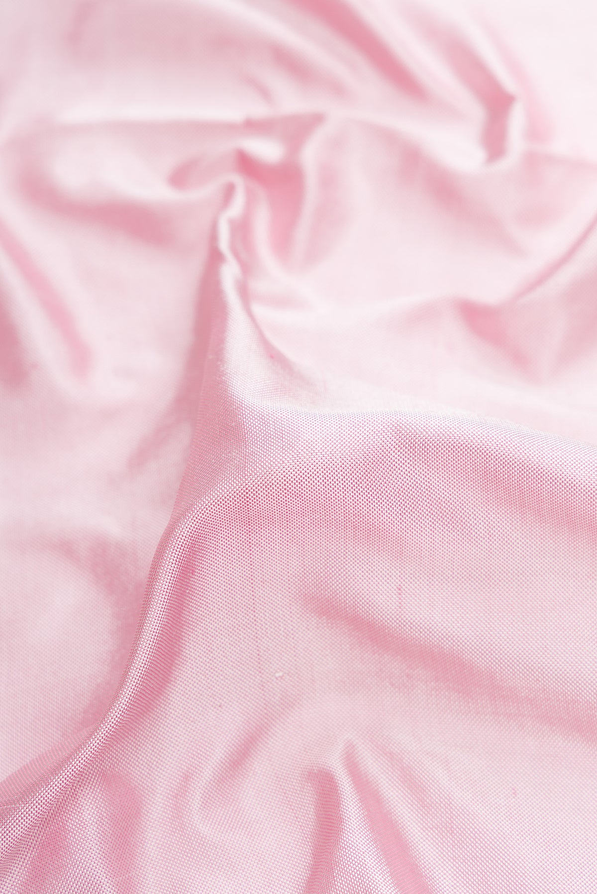 Close up of Pink Double Ikat Saree with Plain Body and Ikat Border.  displaying folds