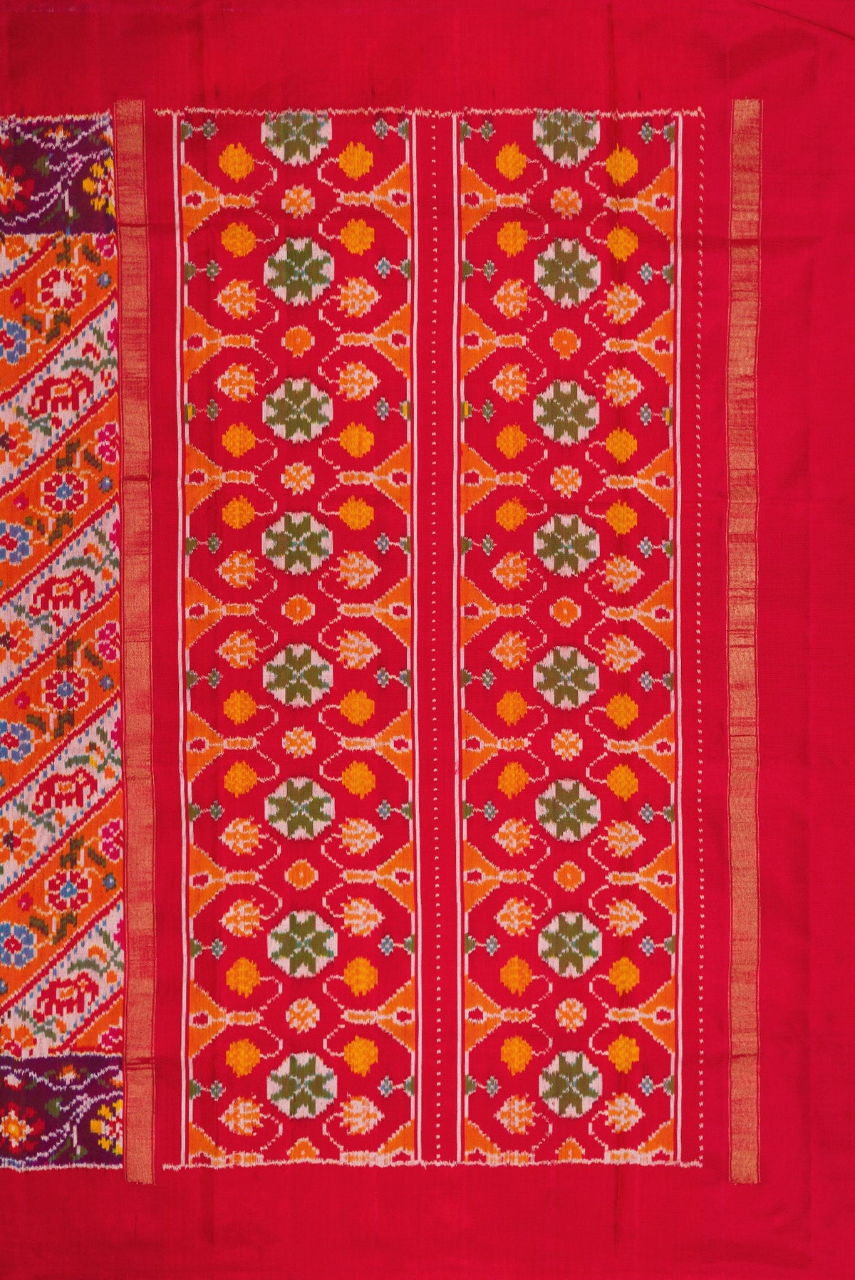 Close up image of the pallu of Brick Orange Dual Tone Double Ikat Saree with Ikat Print on the body and Ikat Border. 