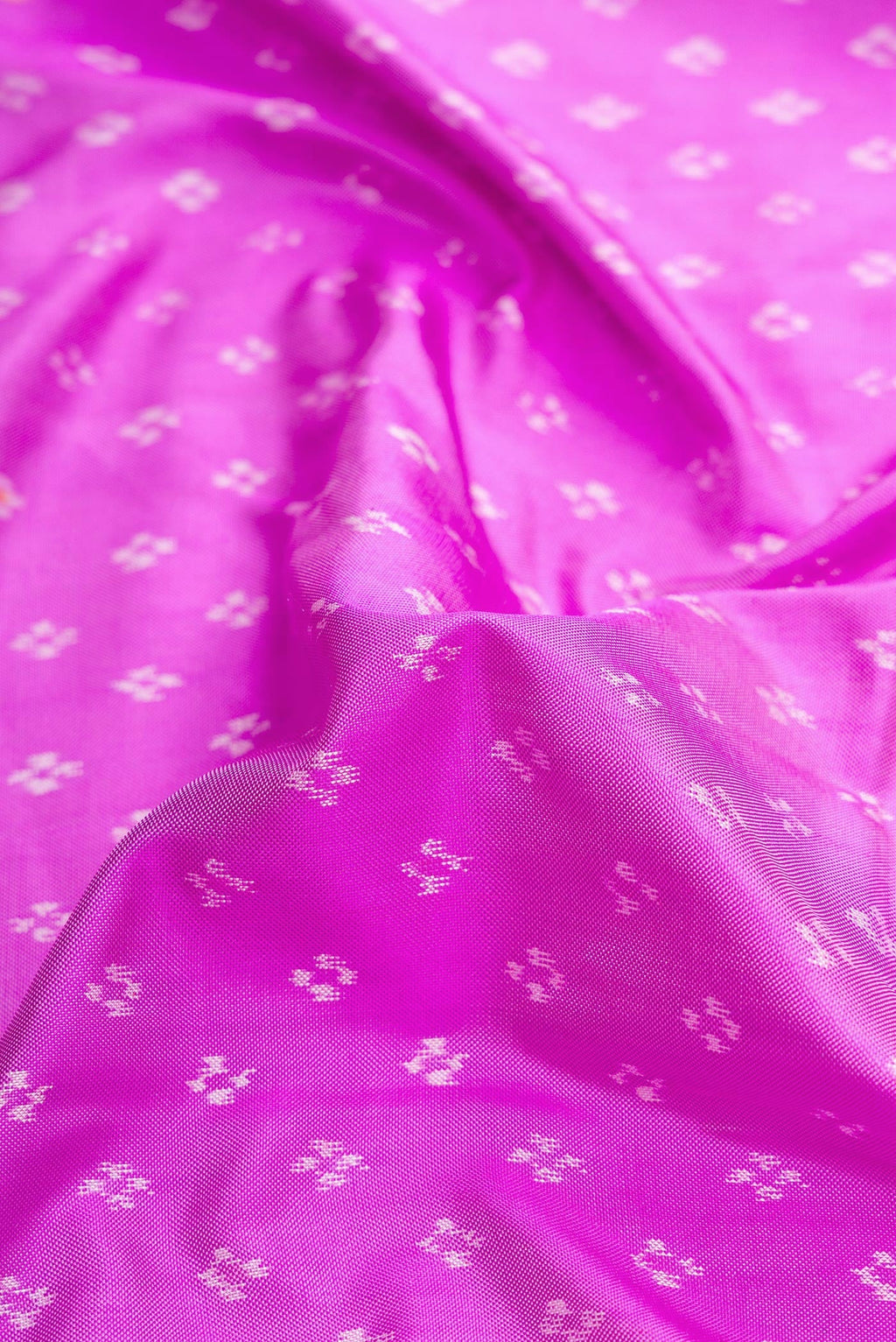 Close up of Pink Dual Tone Double Ikat Saree with Ikat Print on the body and Ikat Border.  displaying folds