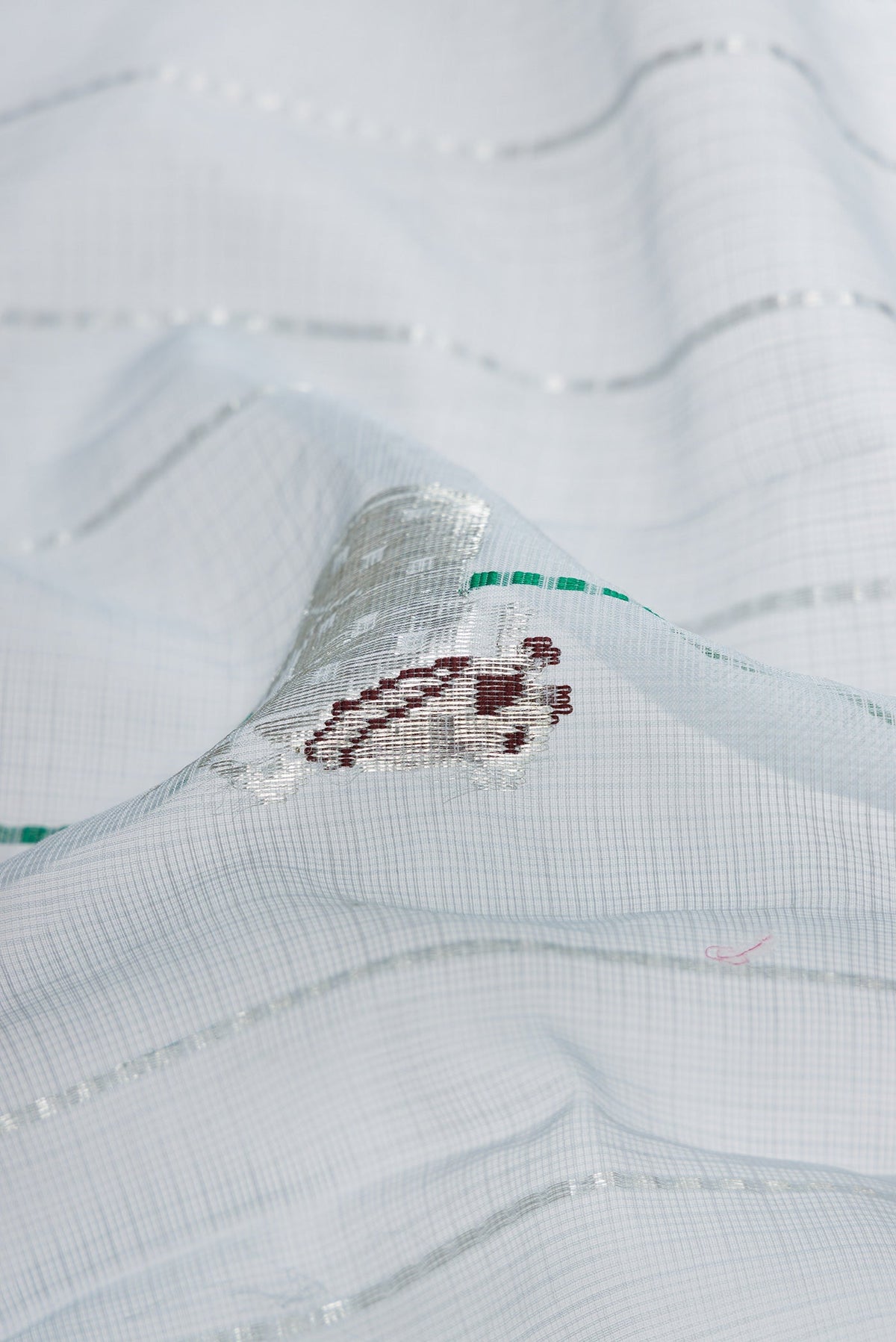 Close up of Grey Dual Tone Kota Silk Saree with Checked design on the body and Zari Border.  displaying folds