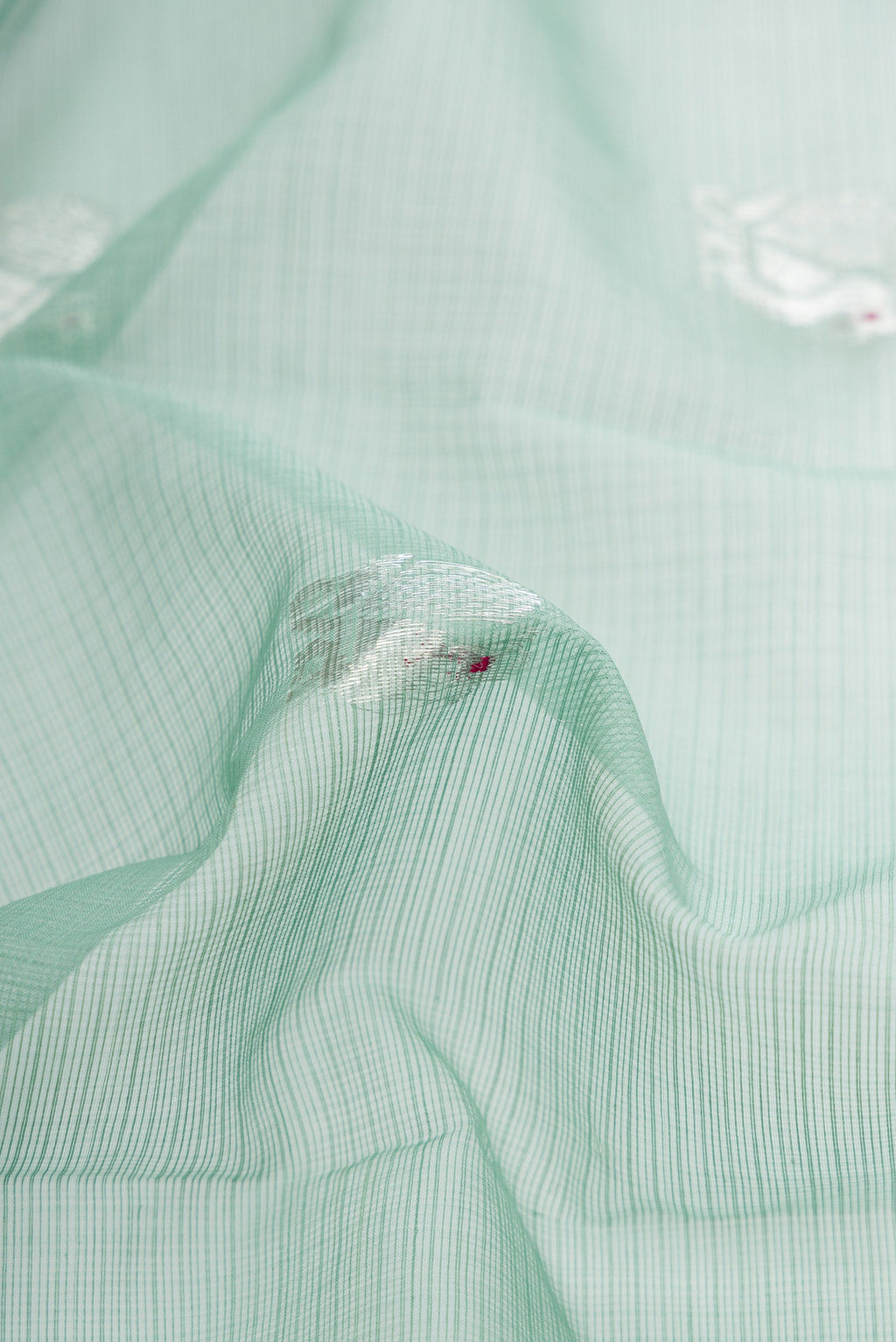 Close up of Sea Green Dual Tone Kota Silk Saree with Zari Butta on the body and Zari Border.  displaying folds