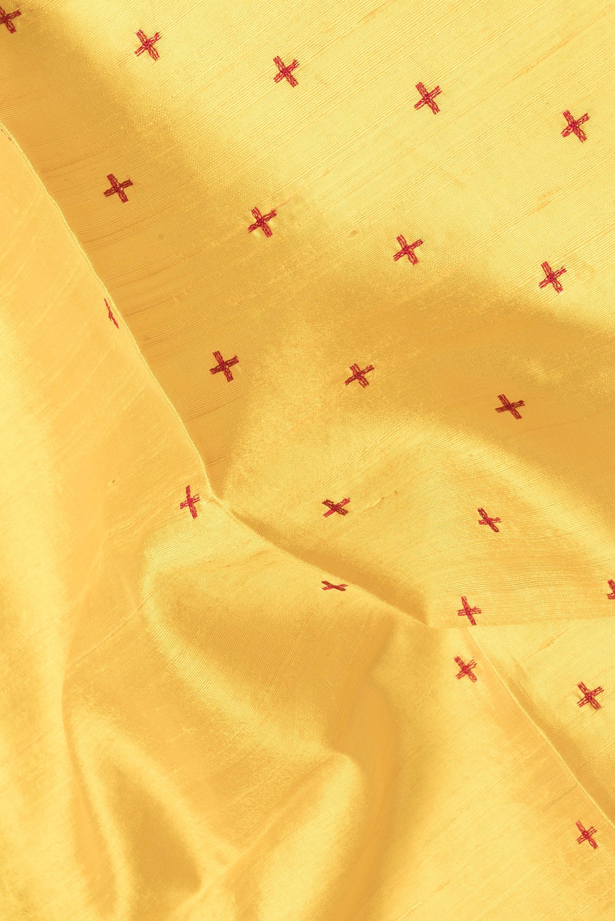 Close up of Yellow Dual Tone Raw Silk Saree with Thread Butta on the body and Thin Zari Line.  displaying folds