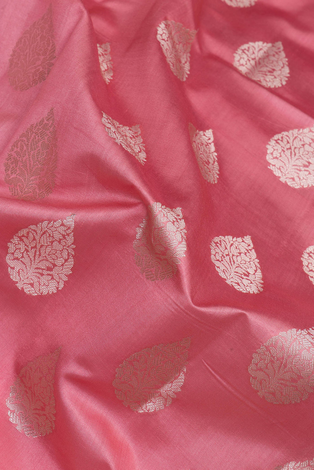 Close up of Pink Tussar Silk Saree with Zari Butta on the body and Zari Border.  displaying folds