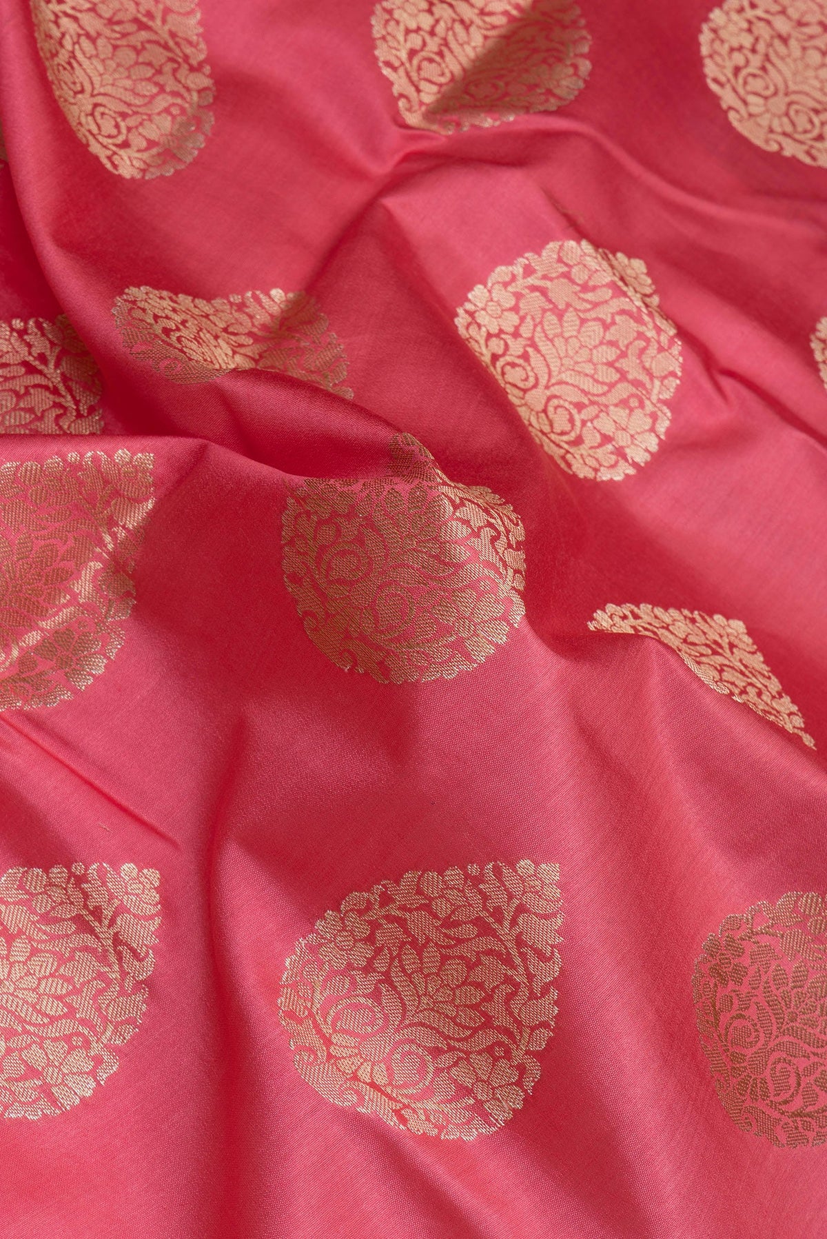 Close up of Pink Tussar Silk Saree with Zari Butta on the body and Zari Border.  displaying folds