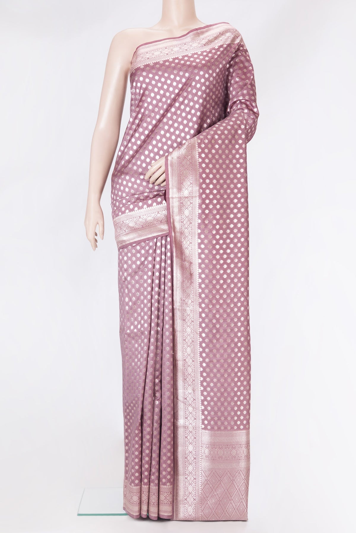 Mauve Tussar Silk Saree with Zari Butta on the body and Zari Border.  displayed on a mannequin