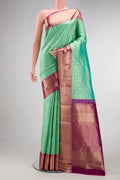 Turquoise Kanchipuram Silk Saree with Zari Brocade on the body and Zari Border.  displayed on a mannequin