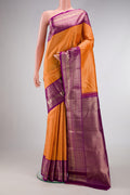 Orange Kanchipuram Silk Saree with Zari Brocade on the body and Zari Border.  displayed on a mannequin