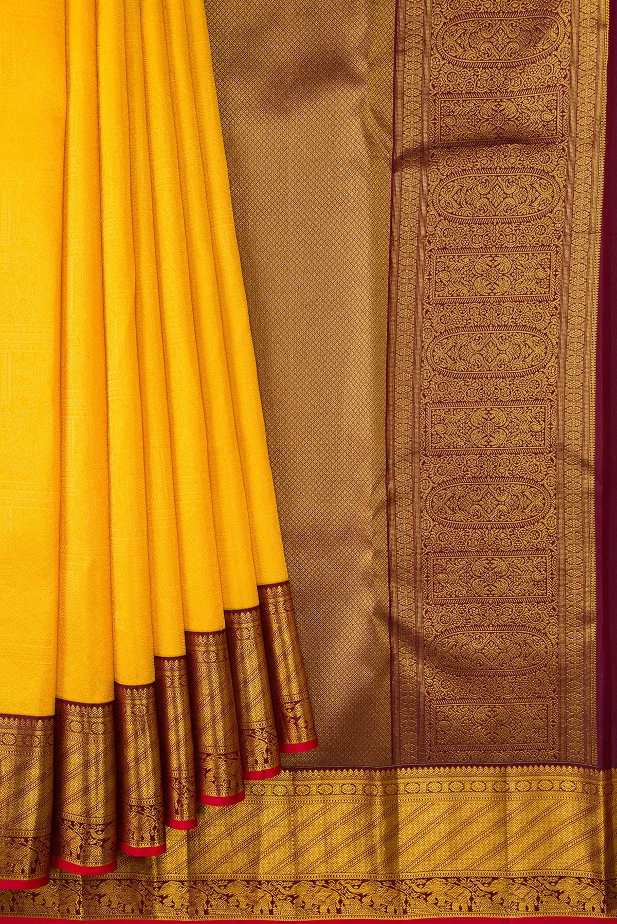 Pleats and pallu of Yellow Kanjivaram Silk Saree with Zari Brocade on the body and Zari Border. 