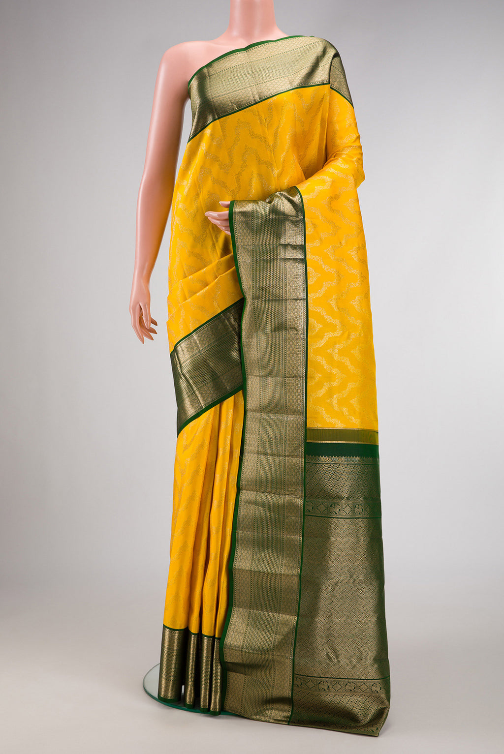 Yellow Kanjivaram Silk Saree with Zari Brocade on the body and Zari Border.  displayed on a mannequin
