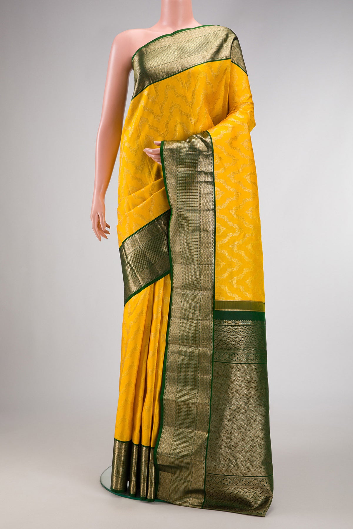 Yellow Kanjivaram Silk Saree with Zari Brocade on the body and Zari Border.  displayed on a mannequin