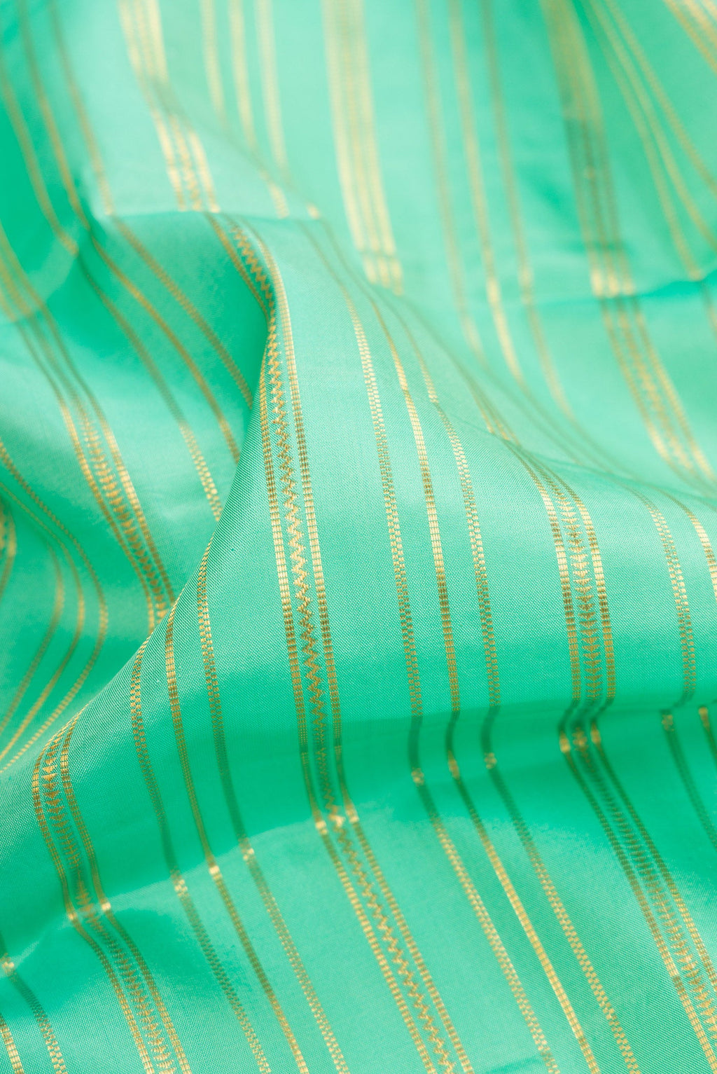 Close up of Sea Green Dual Tone Kanjivaram Silk Saree with Stripes on the body and Zari Border.  displaying folds