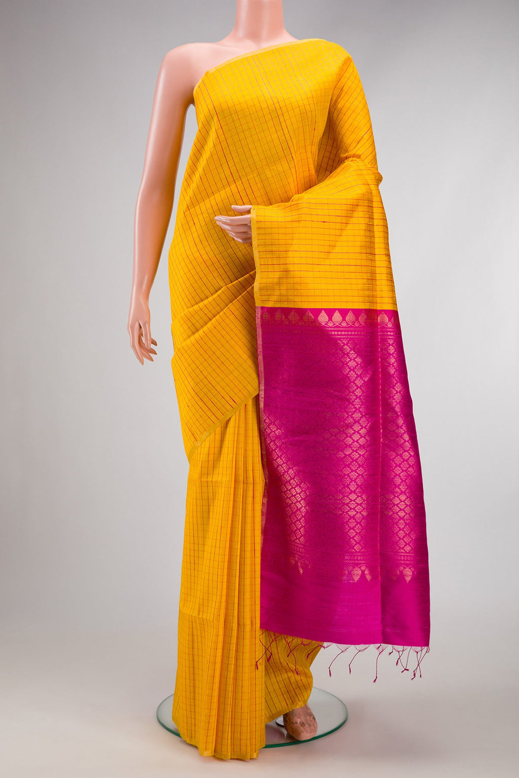 Yellow Dual Tone Raw Silk Saree with Checked design on the body and Zari Border.  displayed on a mannequin
