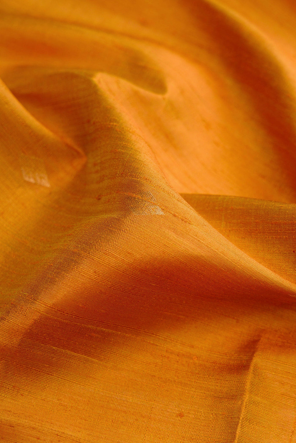 Close up of Mehandi Green Dual Tone Raw Silk Saree with Zari Butta on the body and Zari Border.  displaying folds