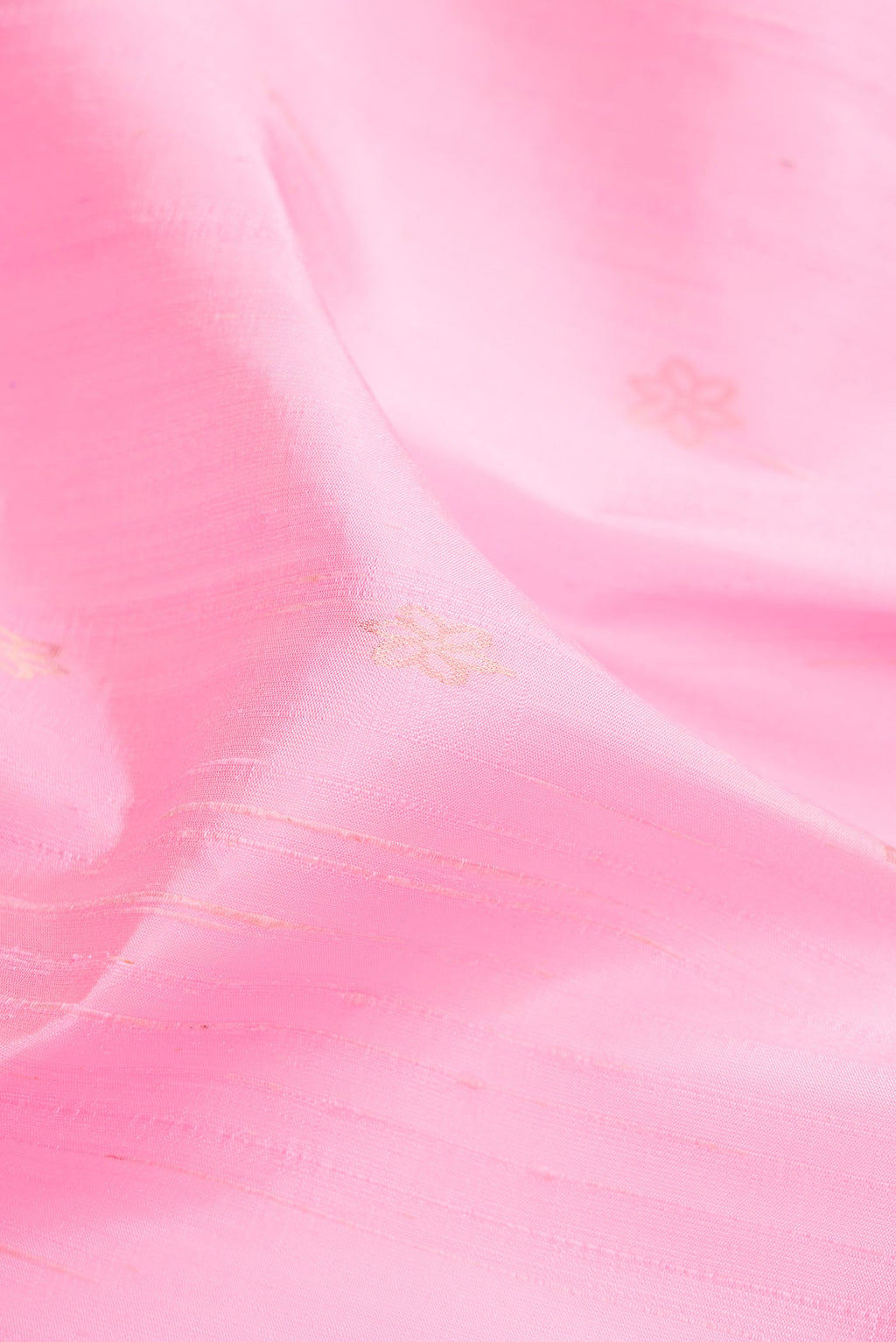 Close up of Rose pink Raw Silk Saree with Zari Butta on the body and Thin Zari Line.  displaying folds