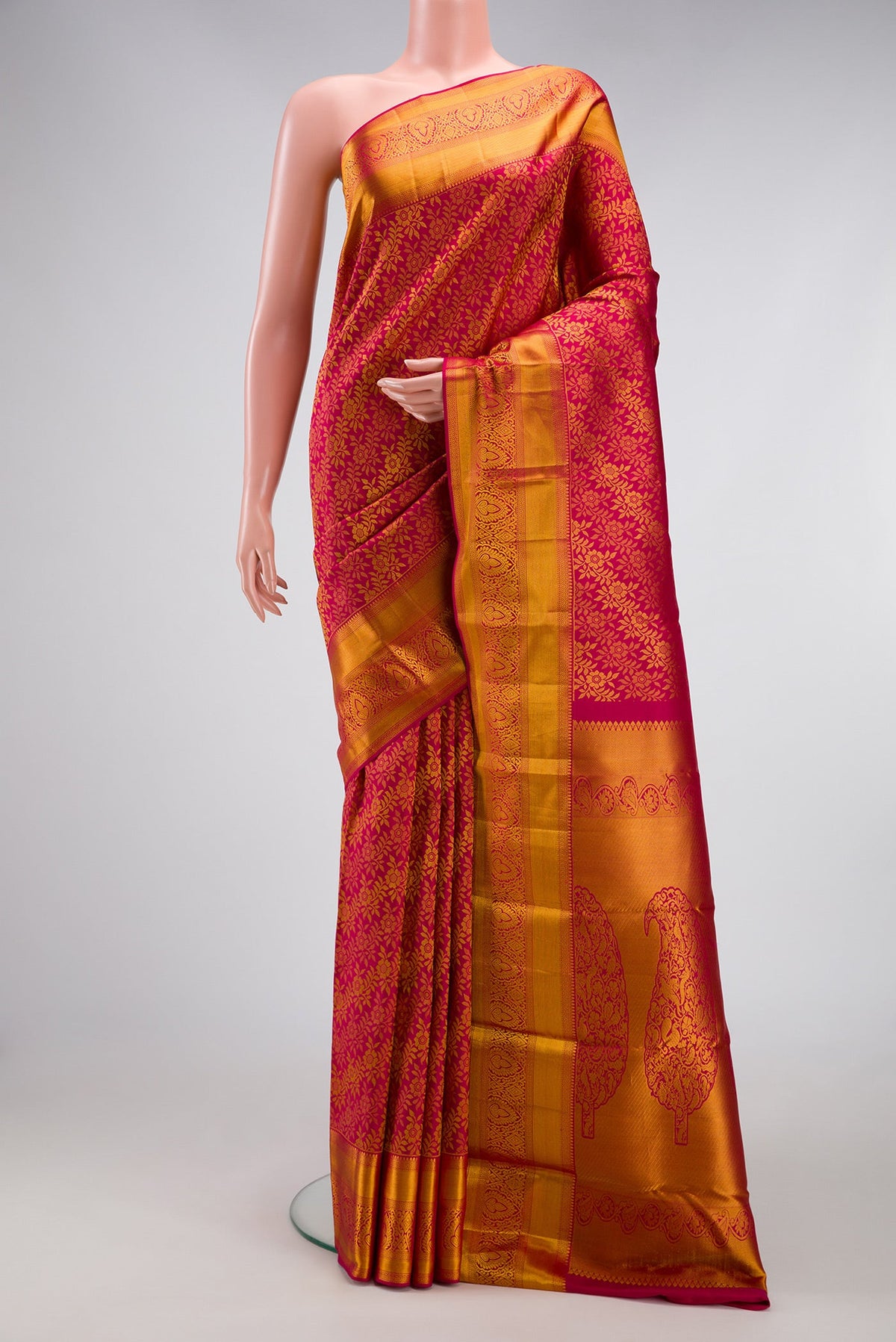Dark Pink Kanjivaram Silk Saree with Zari Brocade on the body and Zari Border.  displayed on a mannequin