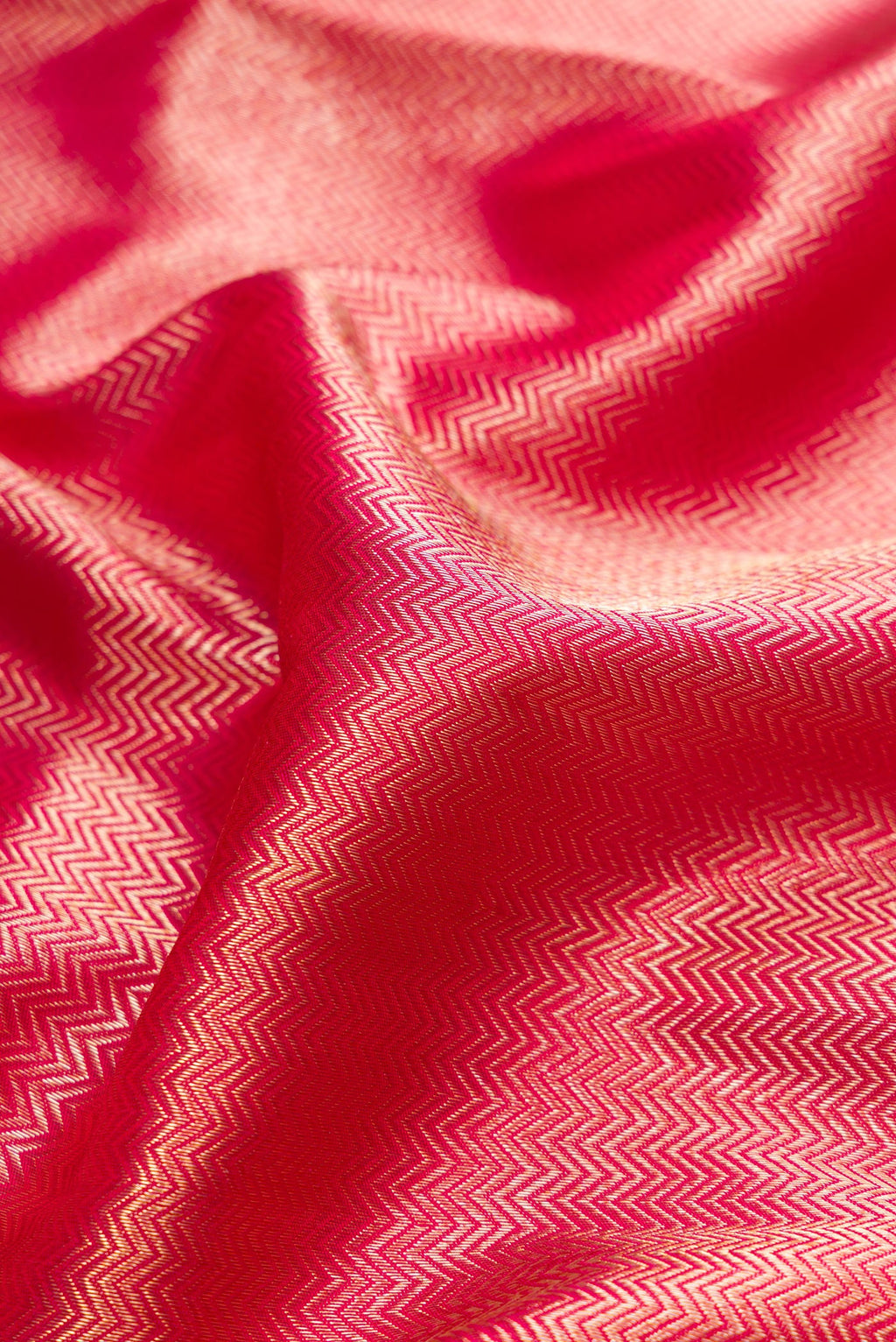 Close up of Pink Dual Tone Kanjivaram Tissue Silk Saree with Zari Brocade on the body and Paithani Border.  displaying folds